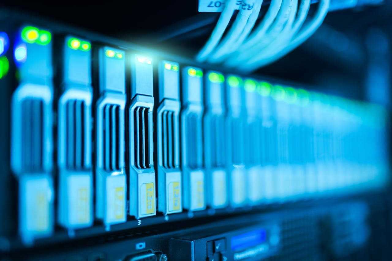 Services-02 Detailed image of a server rack with glowing lights in a modern data center.